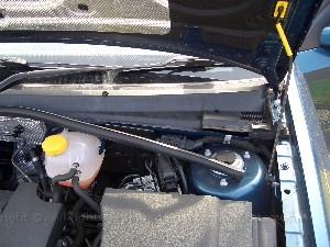 v5voom2casefit7.jpg - To get the power from the battery I found a hold under the baffel sheild near the windscreen which when you remove the gommet goes right behind the dash. The cable feeds through the grommet to protect from the weather. Here you can see a wider shot to get the locations context