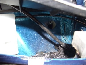 v5voom2casefit8.jpg - To get the power from the battery I found a hold under the baffel sheild near the windscreen which when you remove the gommet goes right behind the dash. The cable feeds through the grommet to protect from the weather